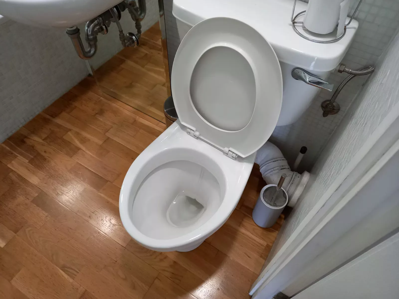 Toilet and bathroom floor cleaned by Nicky's Maid Services